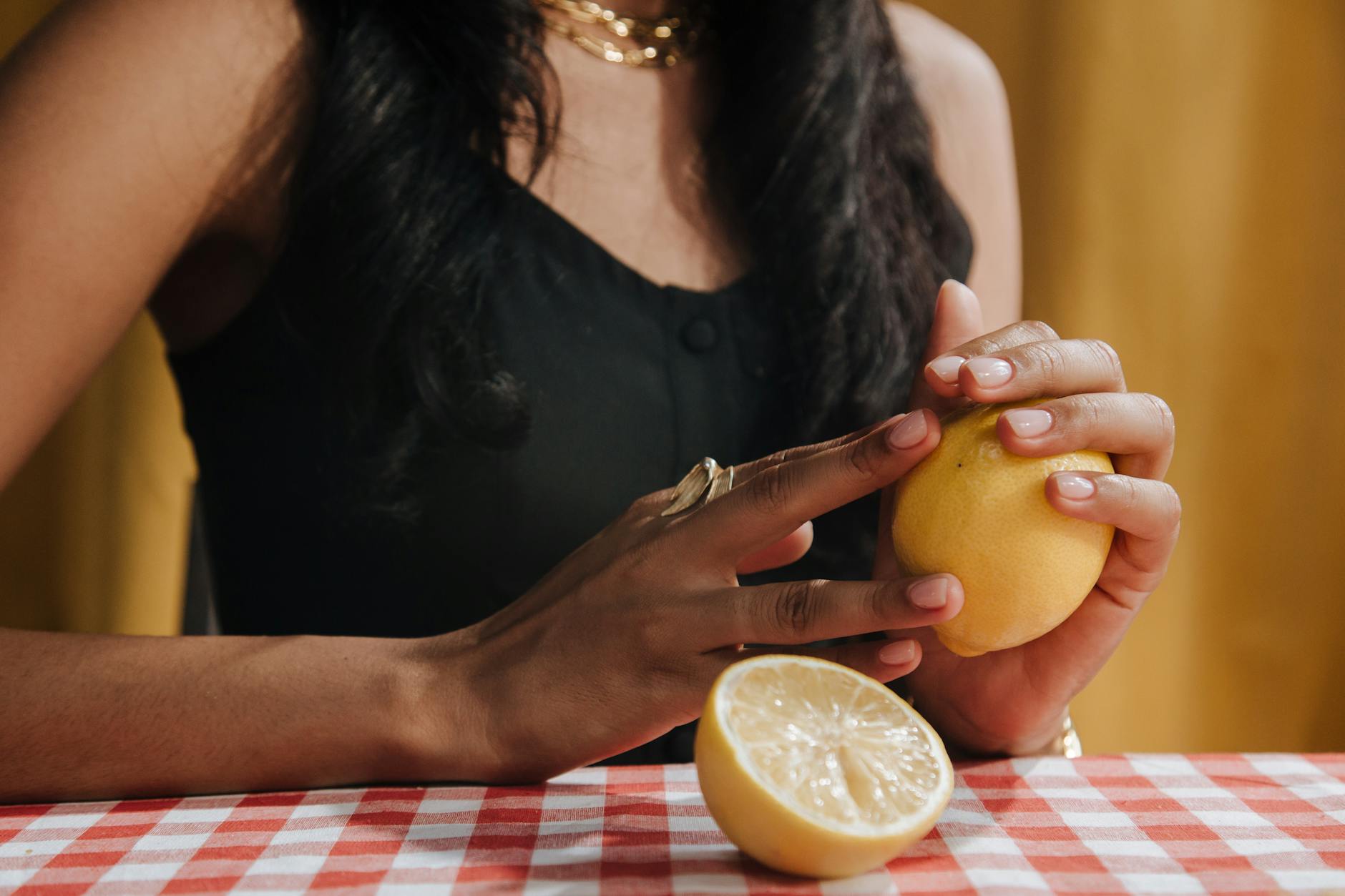 Close-up of two fresh lemons held in cupped hands, symbolizing natural vitality and freshness during midlife