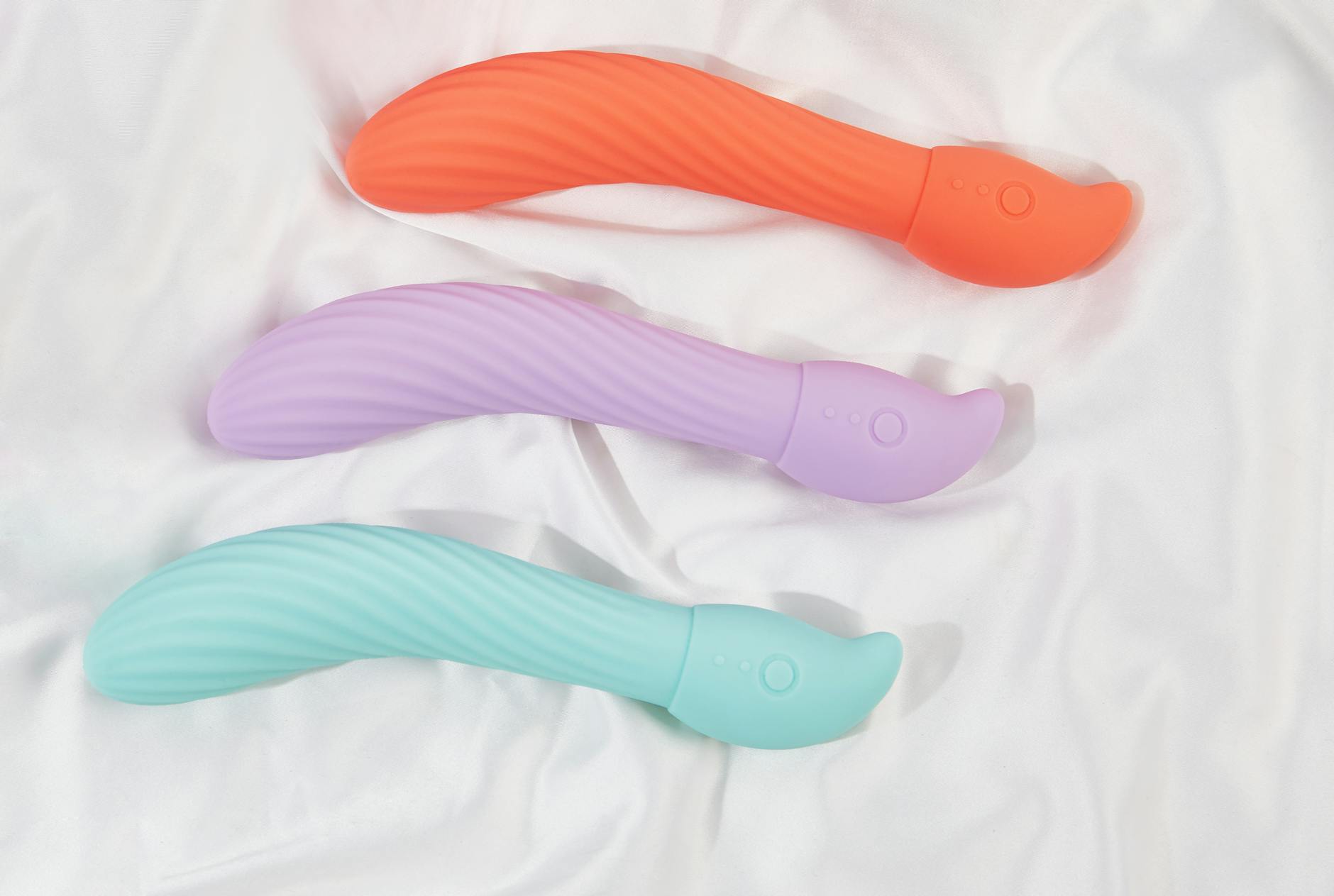 Three colorful lemon vibrators arranged on white fabric, representing different intensities for returning to pleasure