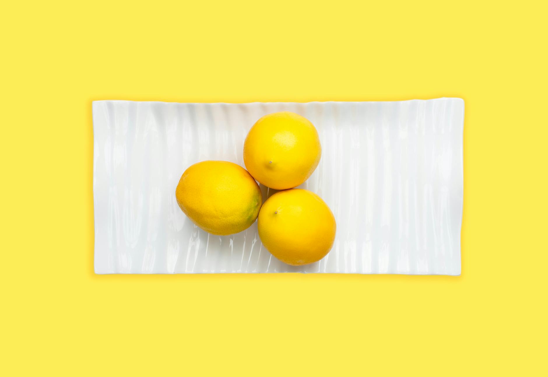 Fresh lemons arranged on a pastel background, symbolizing the natural cycle of sensitivity changes
