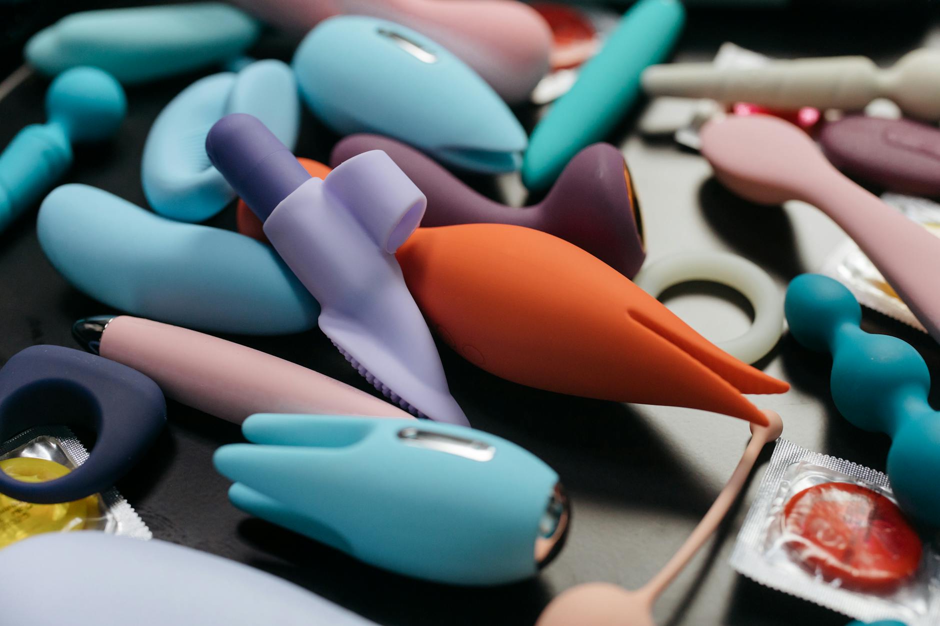 An array of vibrant clitoral vibrators including lemon sucker toys displayed in close-up view