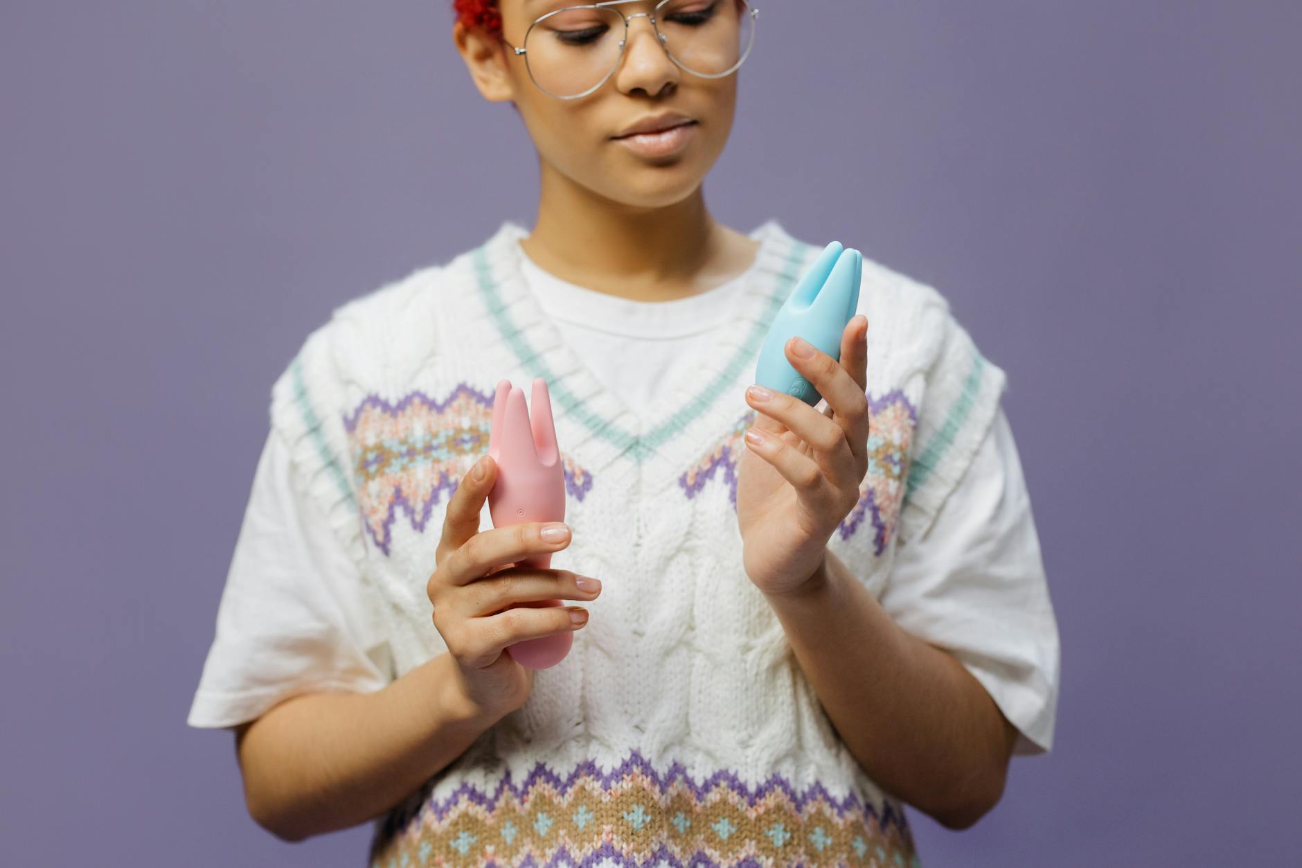 Woman holding lemon vibrators while thinking about how to introduce them to her partner
