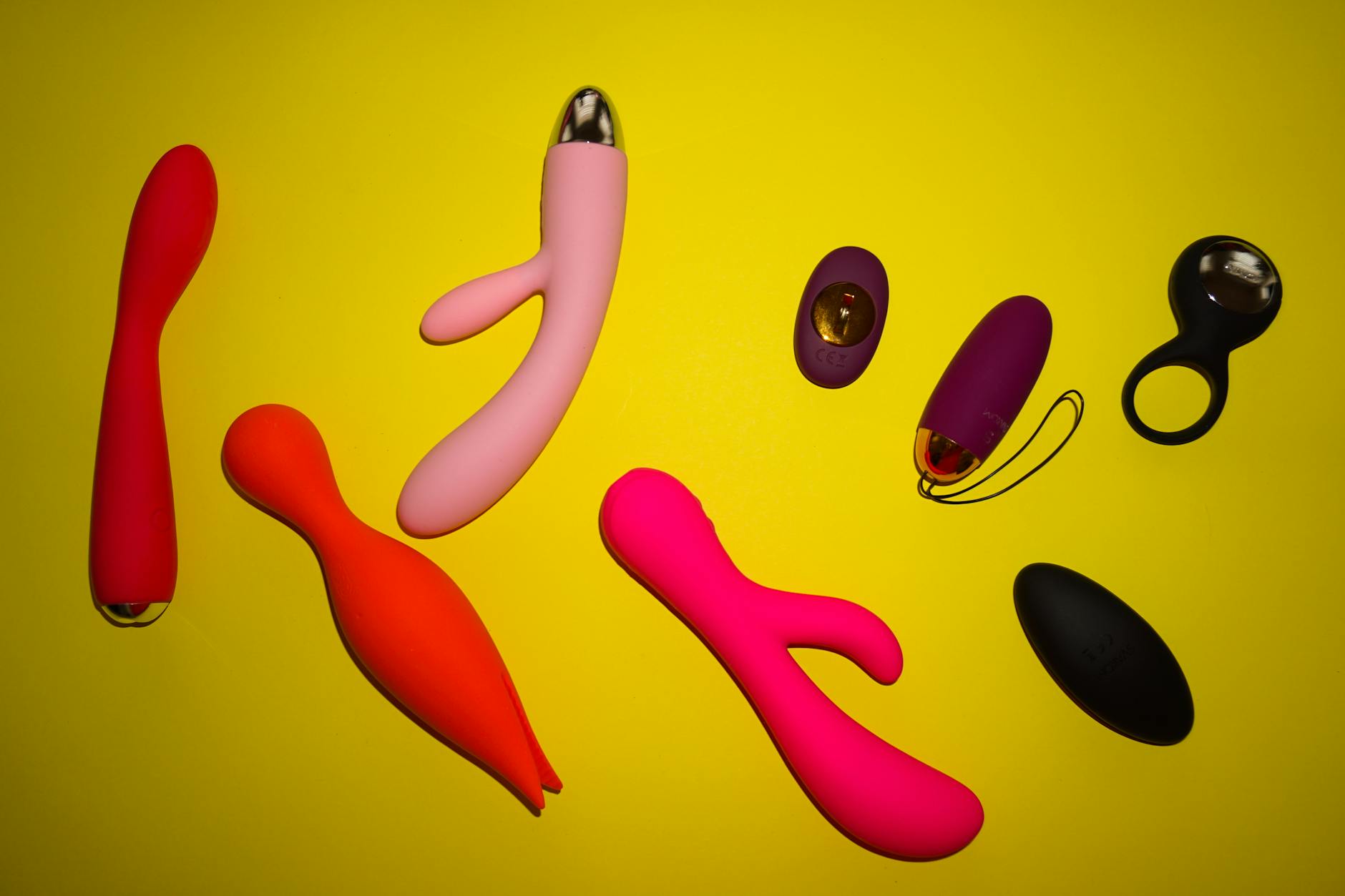 A blue silicone vibrator held in hand against a solid background, symbolizing self-care and pleasure recovery